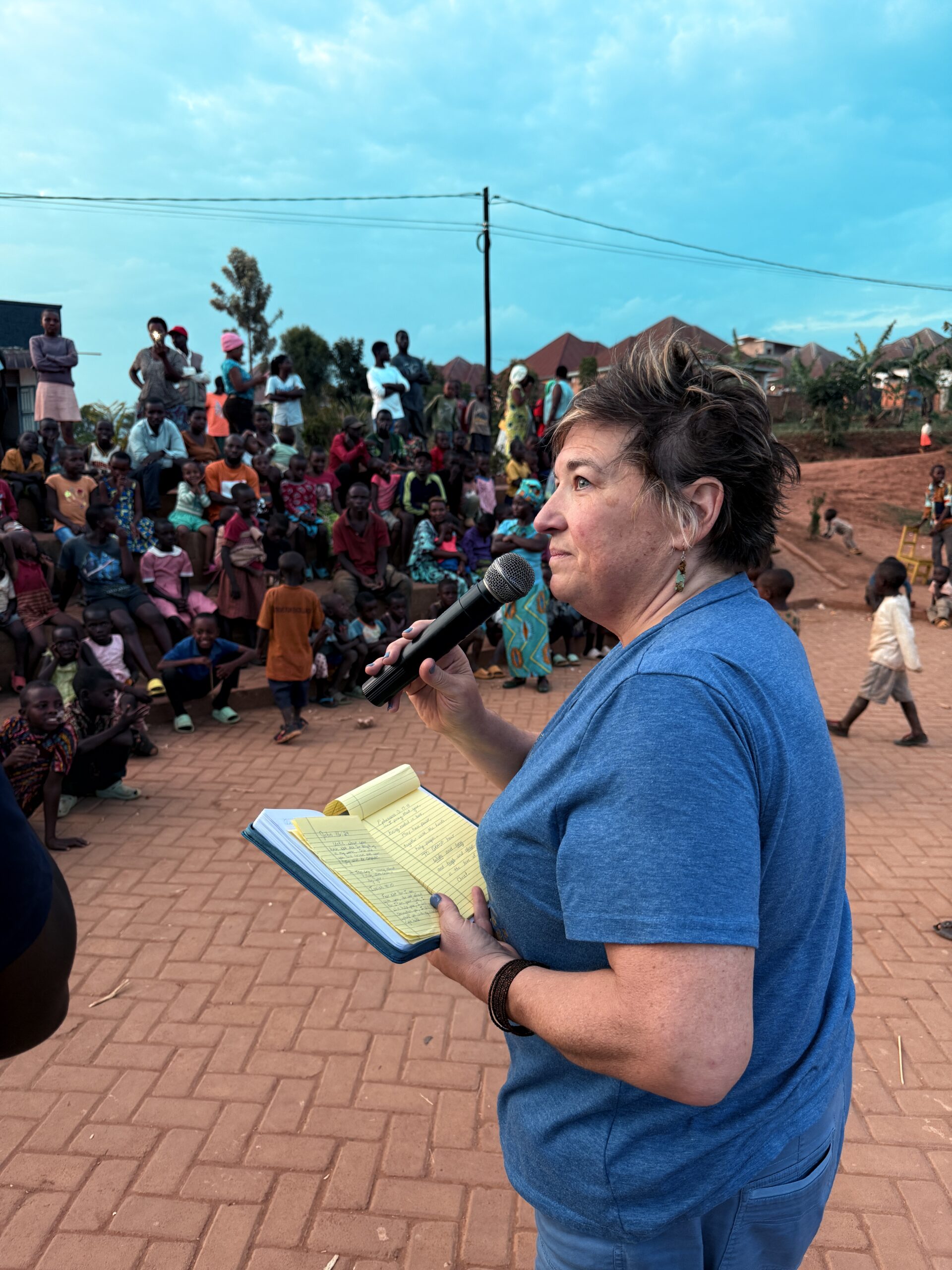 Elaine speaking to a community gathered in the courtyard