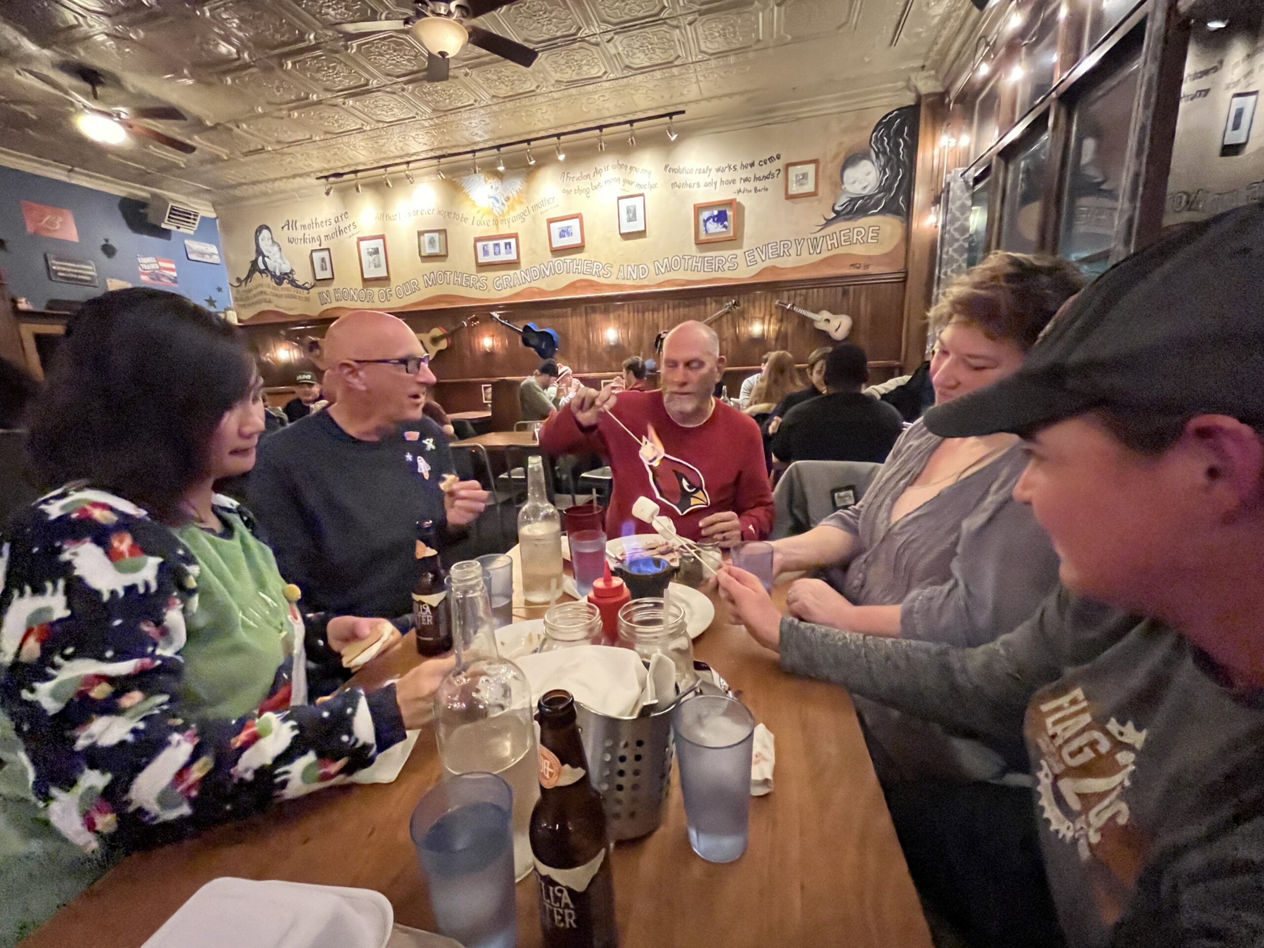 Retreat group around a long table, sharing a meal