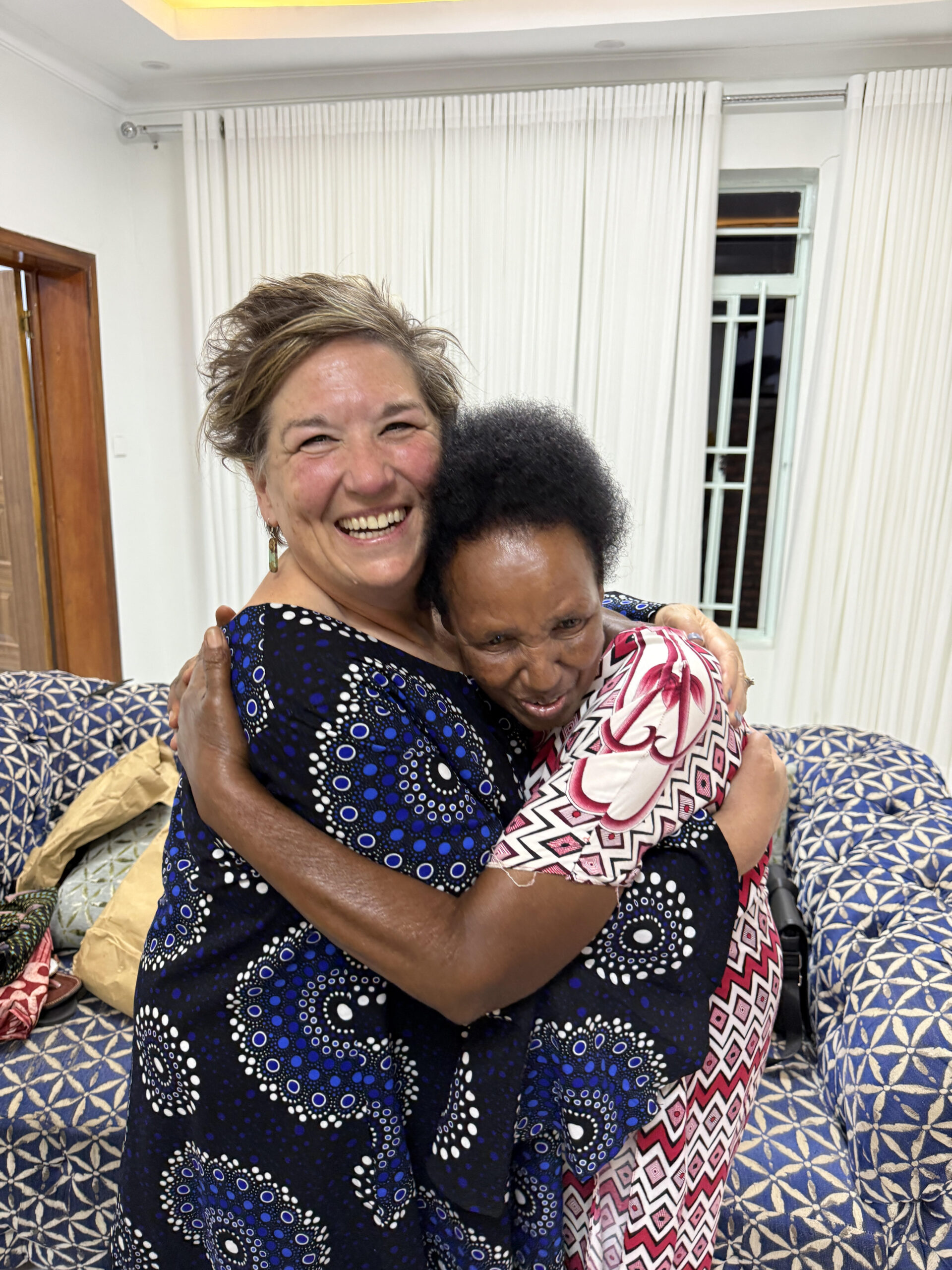 Elaine and a sister in joyful embrace
