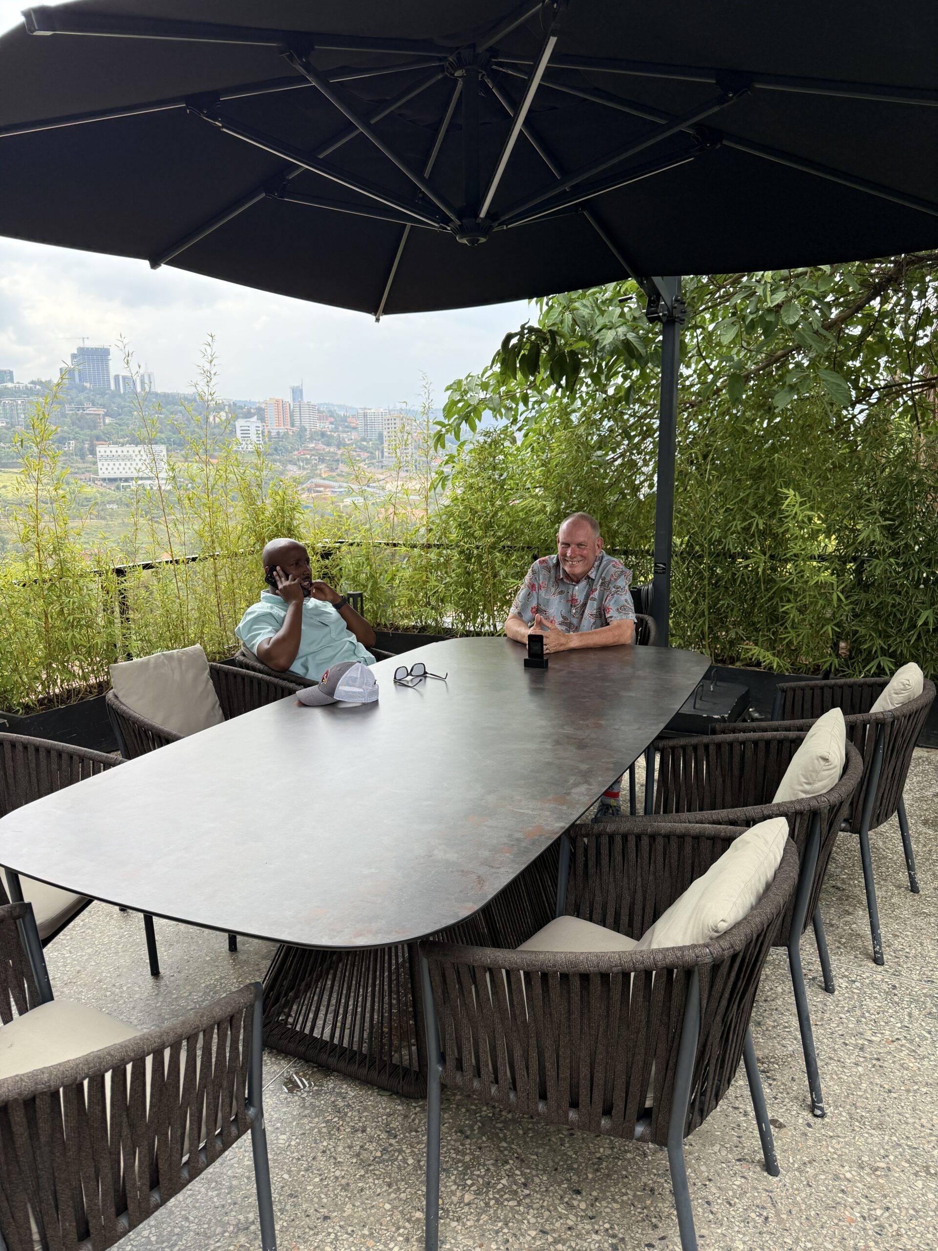 Bill and a mentee at an outdoor table, slow conversation
